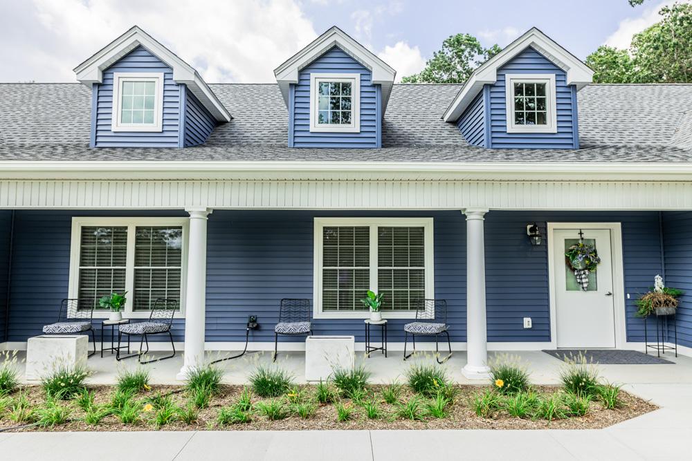 The exterior of a blue house is shown.