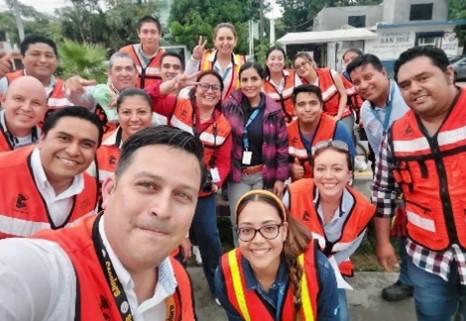 A group of volunteers posed in safety vests.