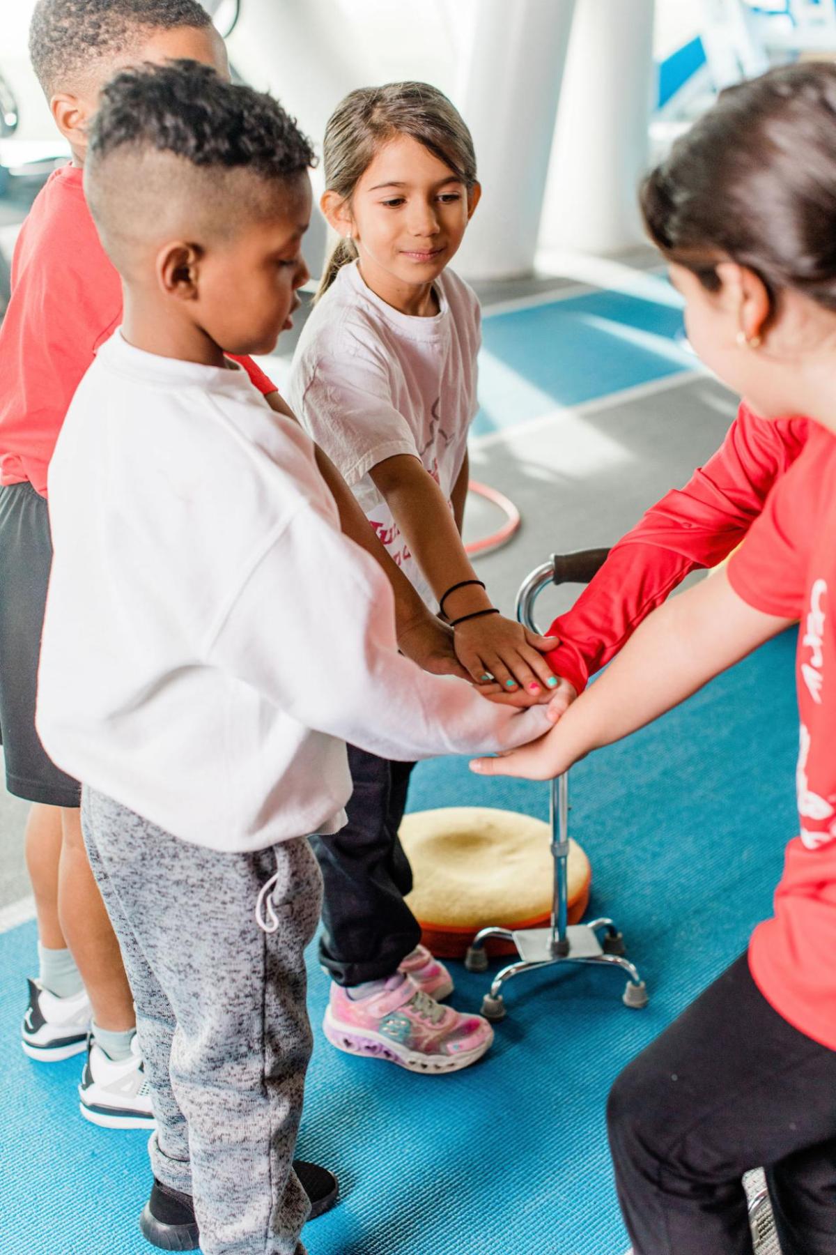 Four children holding hands.