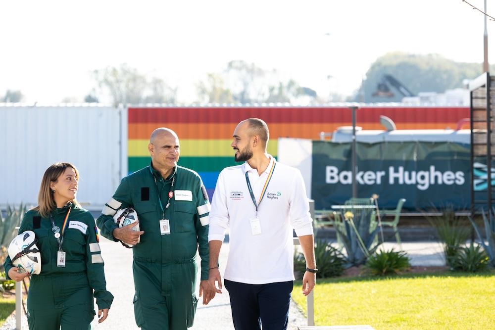 Three employees walking together outside