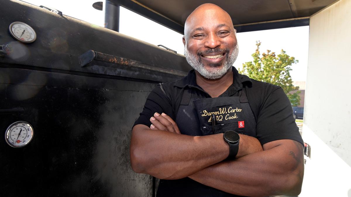 Darren W. Carter with the smoker he uses for his BBQ food truck.