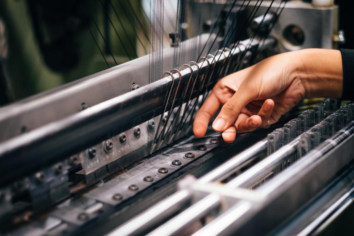 Hands working on knitting machine