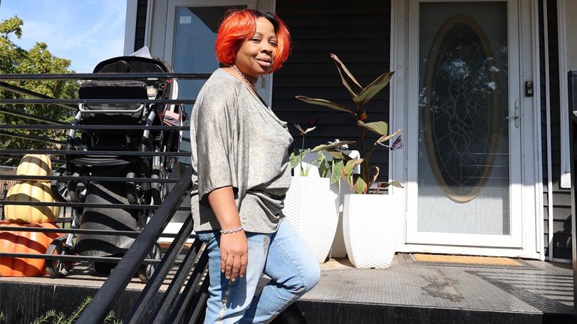 Women stands in front of her home in Chicago