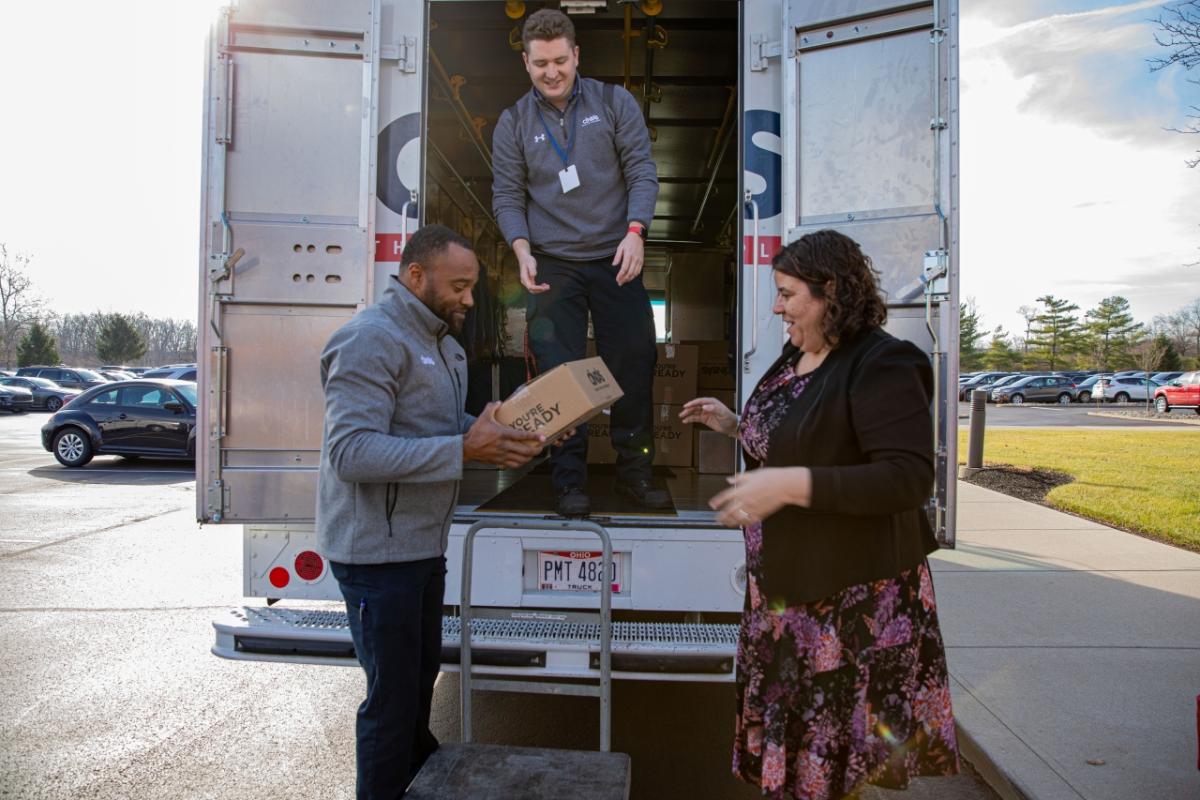 group putting boxes in Cintas truck