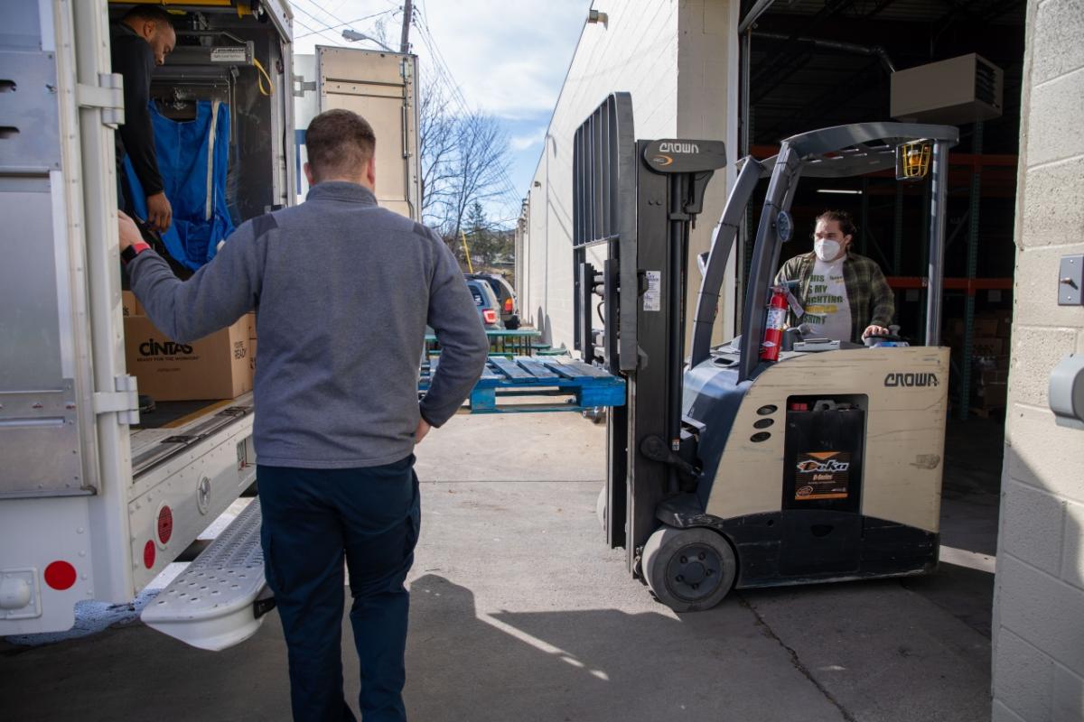 forklift putting boxes in truck