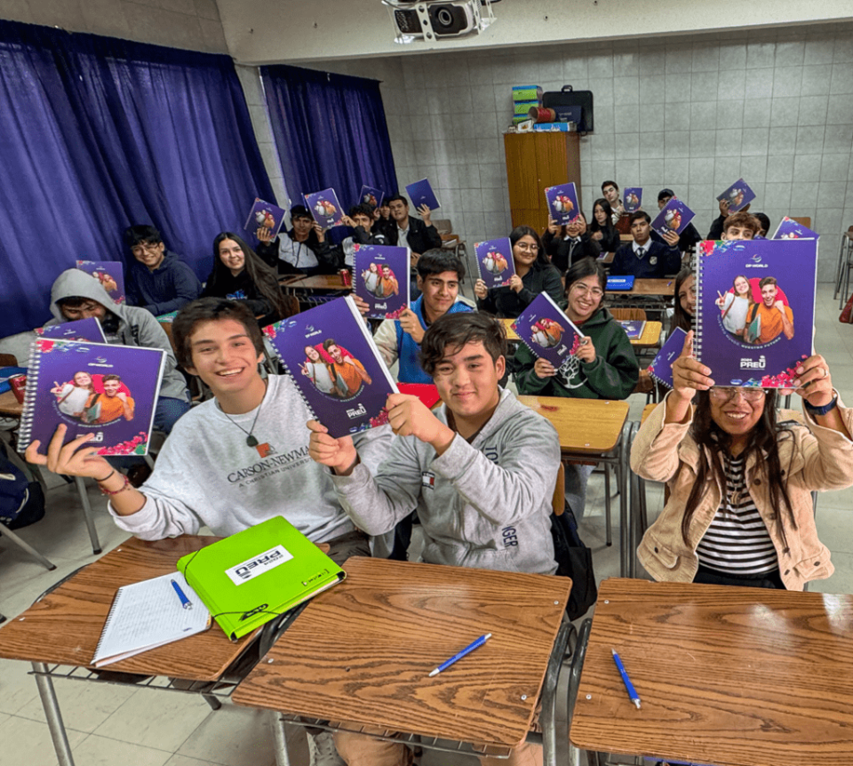 Classroom of students holding up notebooks