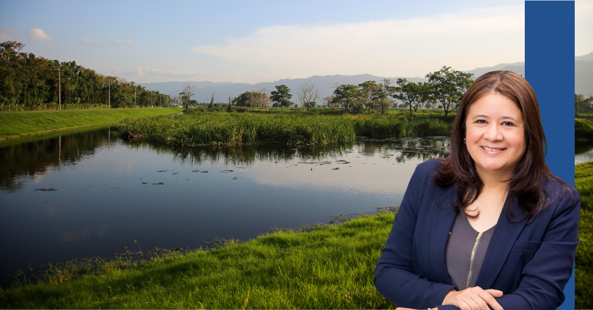 Headshot of Claudia Sandoval against a water and trees backdrop