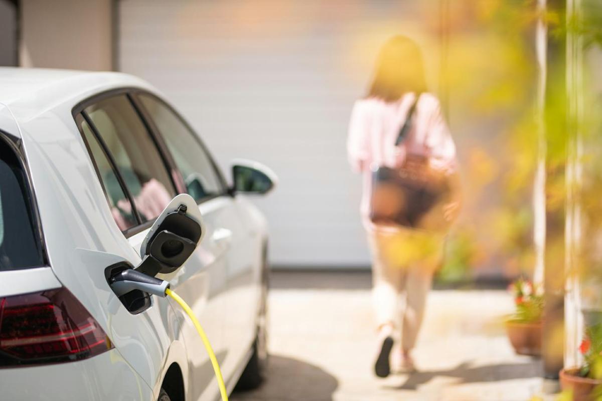 EV charges while person walks away