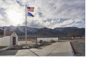 Flags flying with mountains in the background