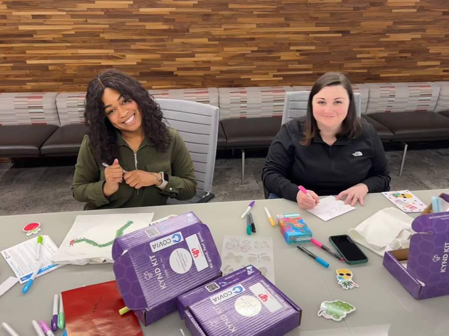 2 people at a table making cards