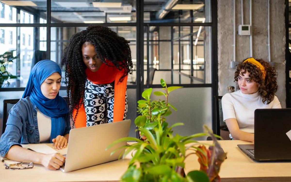 diverse women working on laptops