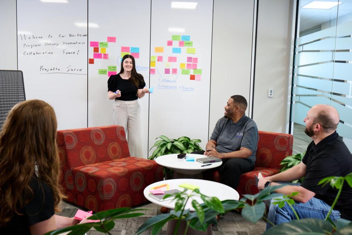 People talking together in front of a whiteboard