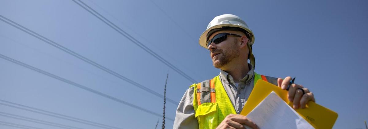 Will Ricks wearing a safety hat and hi-viz