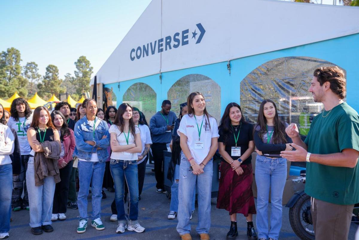 Group of students listening to speaker outside