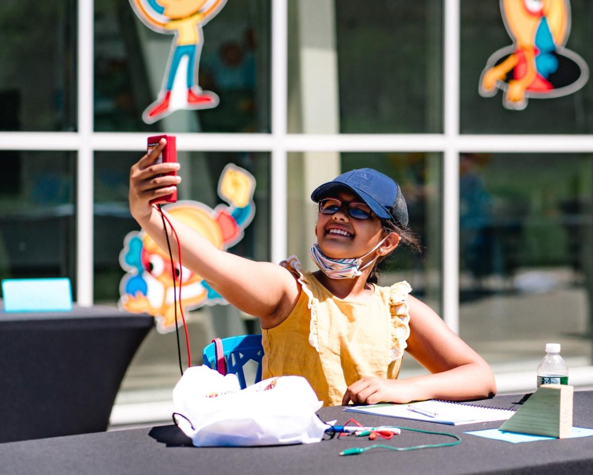 Girl holding up science project