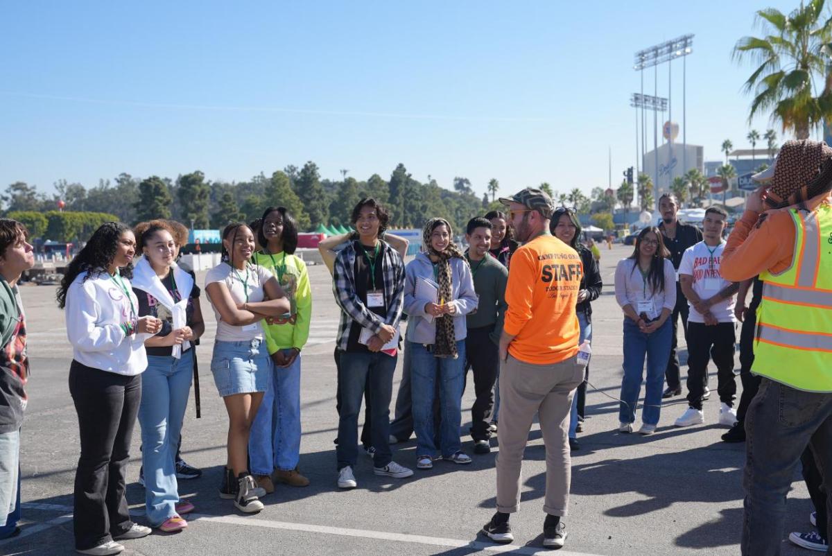 Group of students listening to a speaker outside