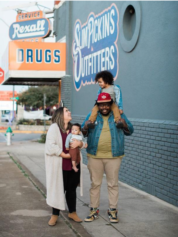 Jahmicah and Heather Dawes with their two children in front of Slim Pickins Outfitters.