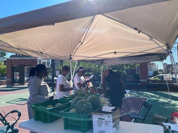 Folks shown at the Delavan-Grider farmers market in Buffalo. 