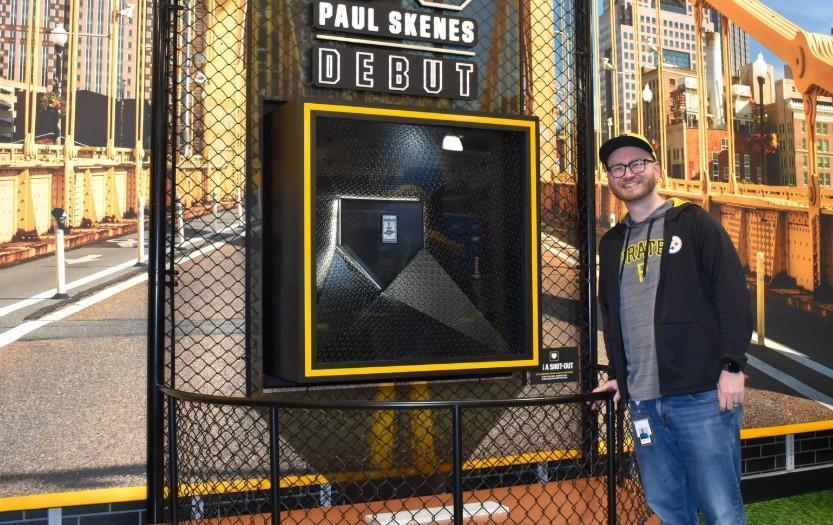 Travis Rogan posing with the Skenes MLB Debut Patch card.