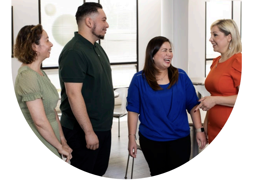 Four people stood together smiling 