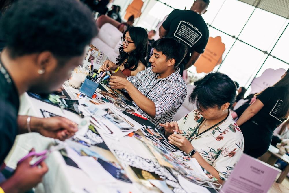 Group sitting at a table cutting paper and making artwork