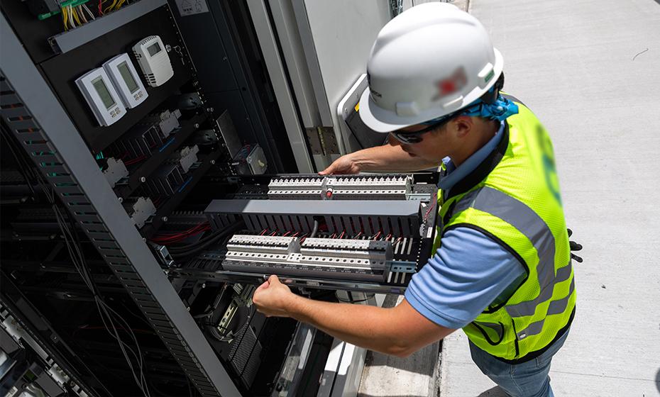 person working on electrical equipment