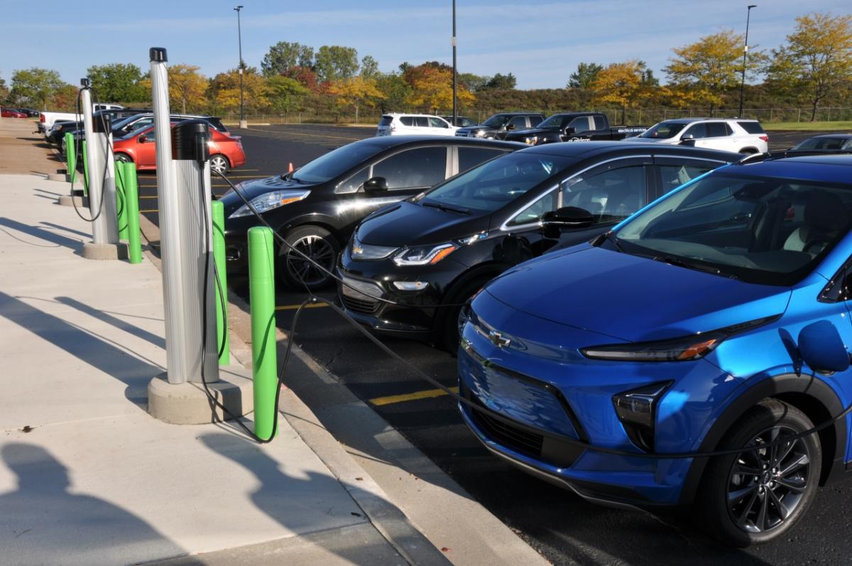 cars parked by EV charging stations