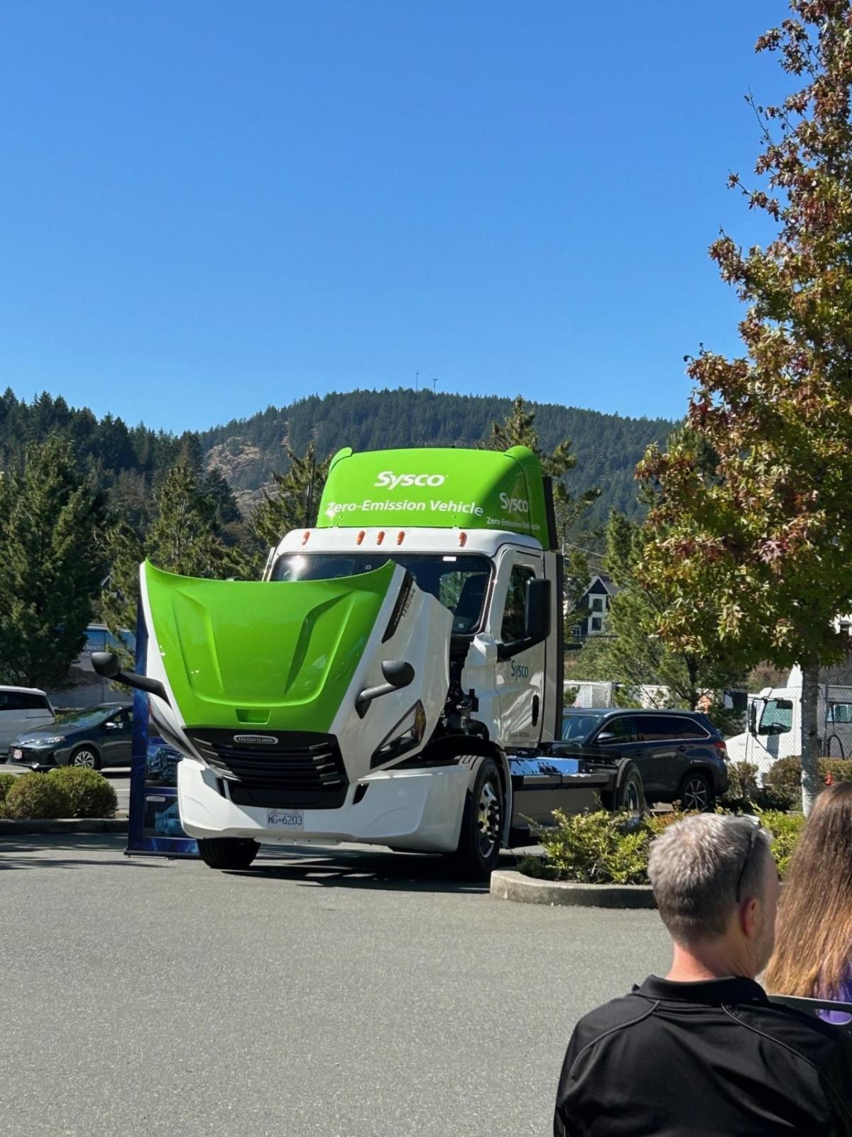 A Sysco semi truck with the hood open.