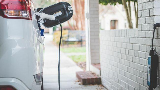 An electric vehicle plugged in to a home charger.