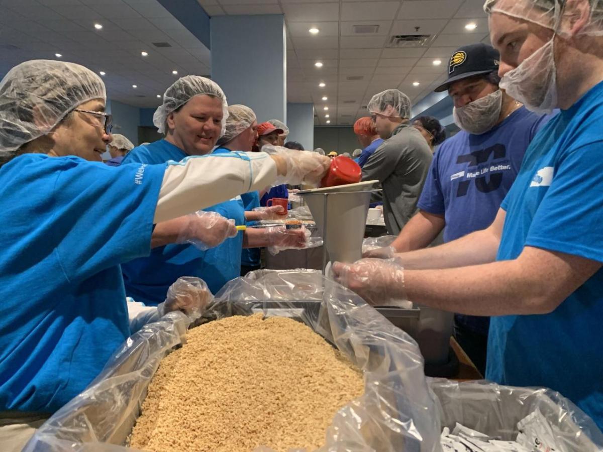 Elanco employees packing food