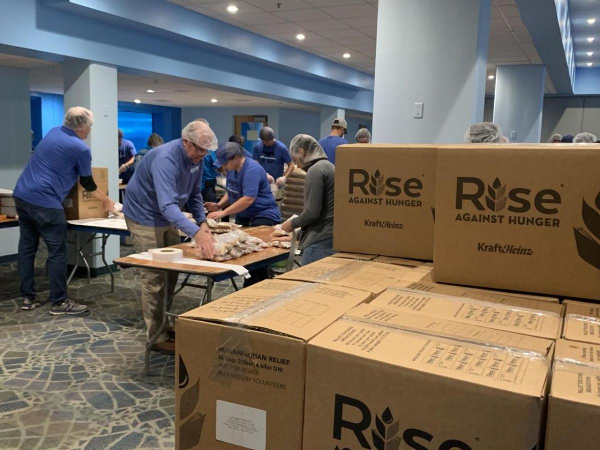 Employees packing up meals into boxes