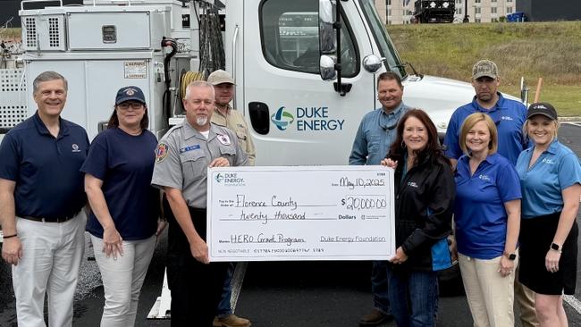 First responders holding check from Duke Energy