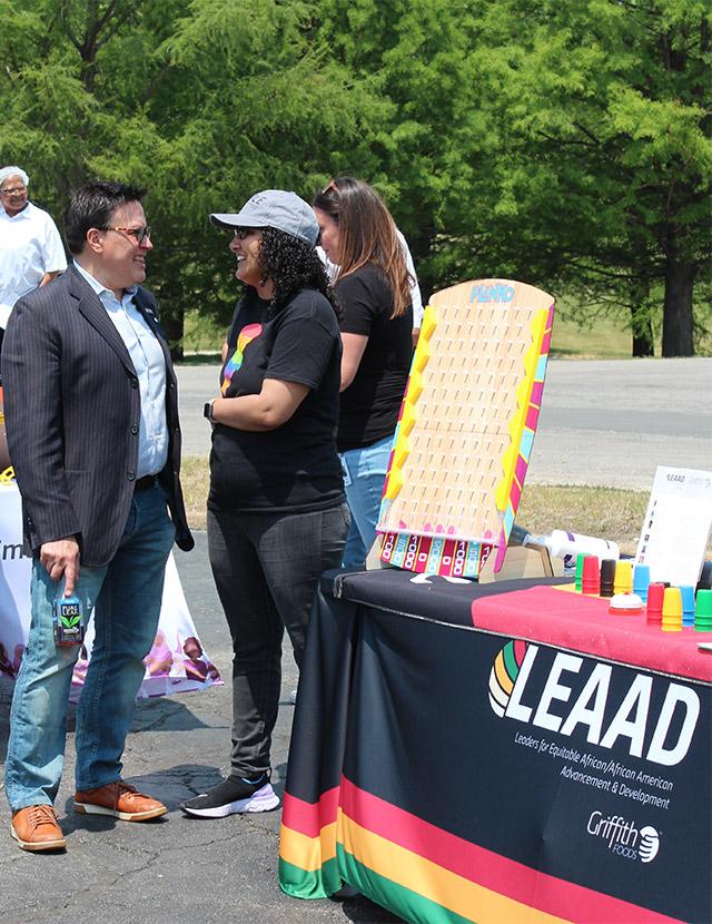 Two people stood talking at an event stand