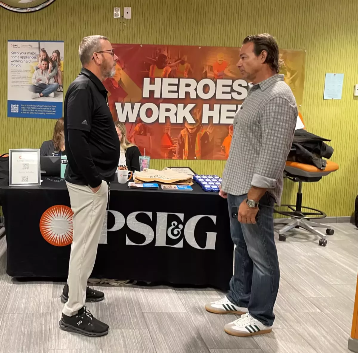 people talking in front of a PSEG table