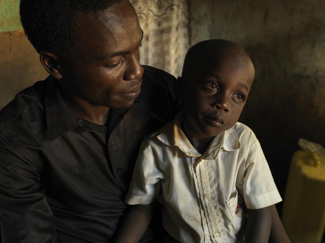 Ernest's son sits in his lap