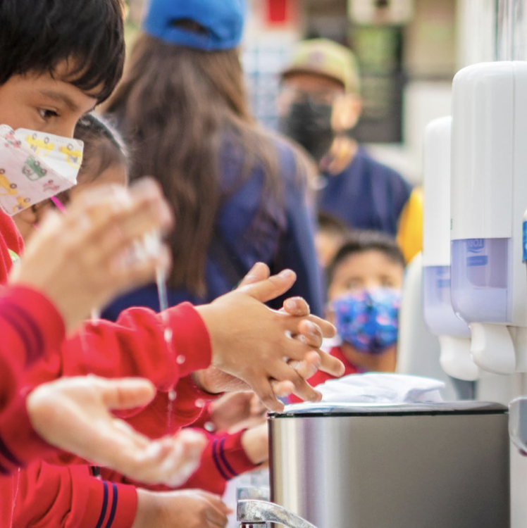 Children washing their hands.