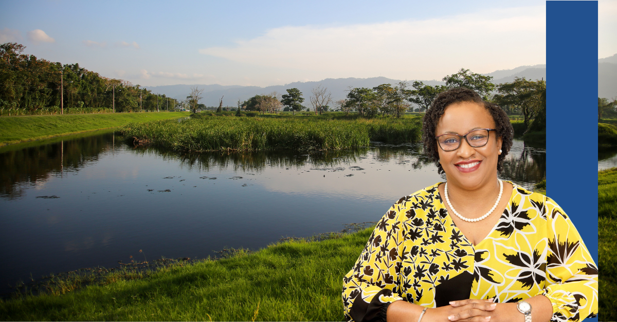 Headshot of Esther Hackett against a water and trees backdrop