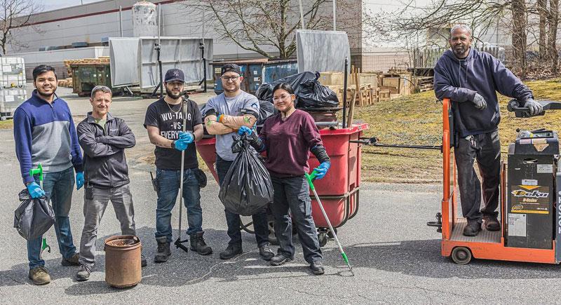 group of volunteers cleaning outside