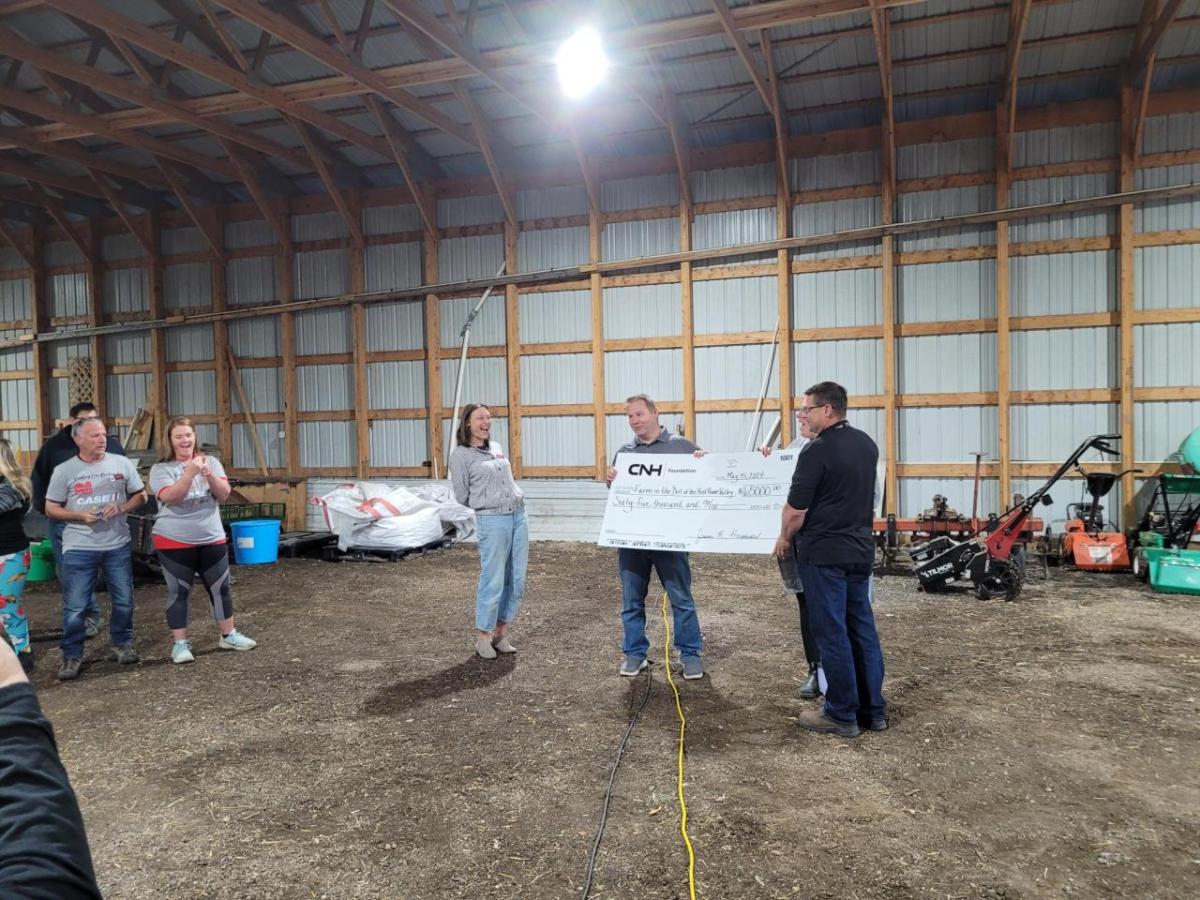 Two people holding a large cheque 