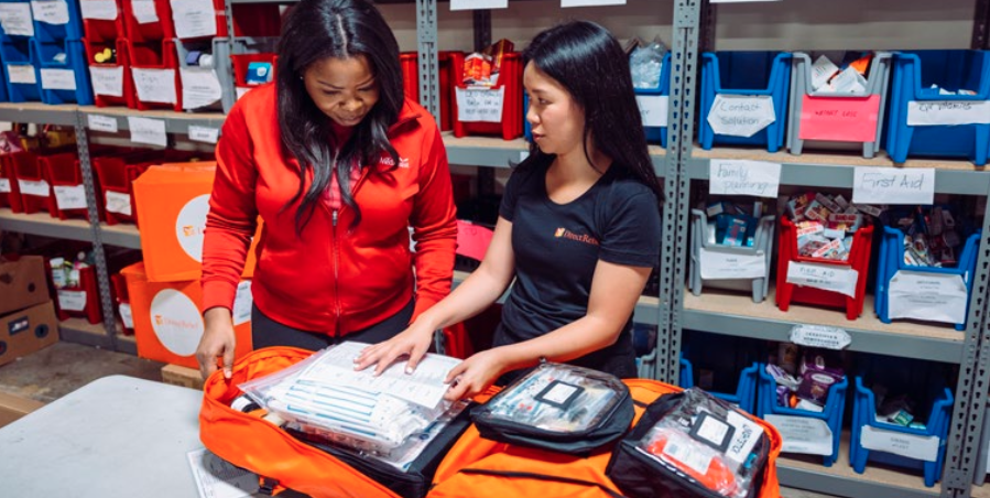 A Direct Relief team member showcases the contents of one of the emergency medical backpacks