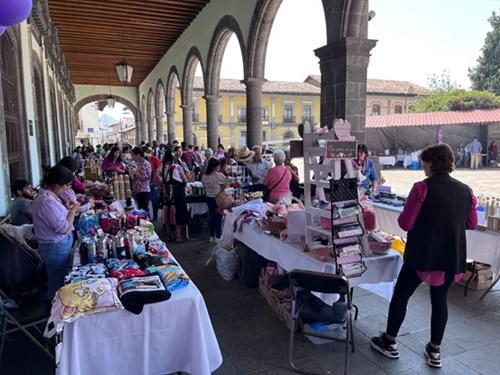 A long covered walkway with craft vendors.