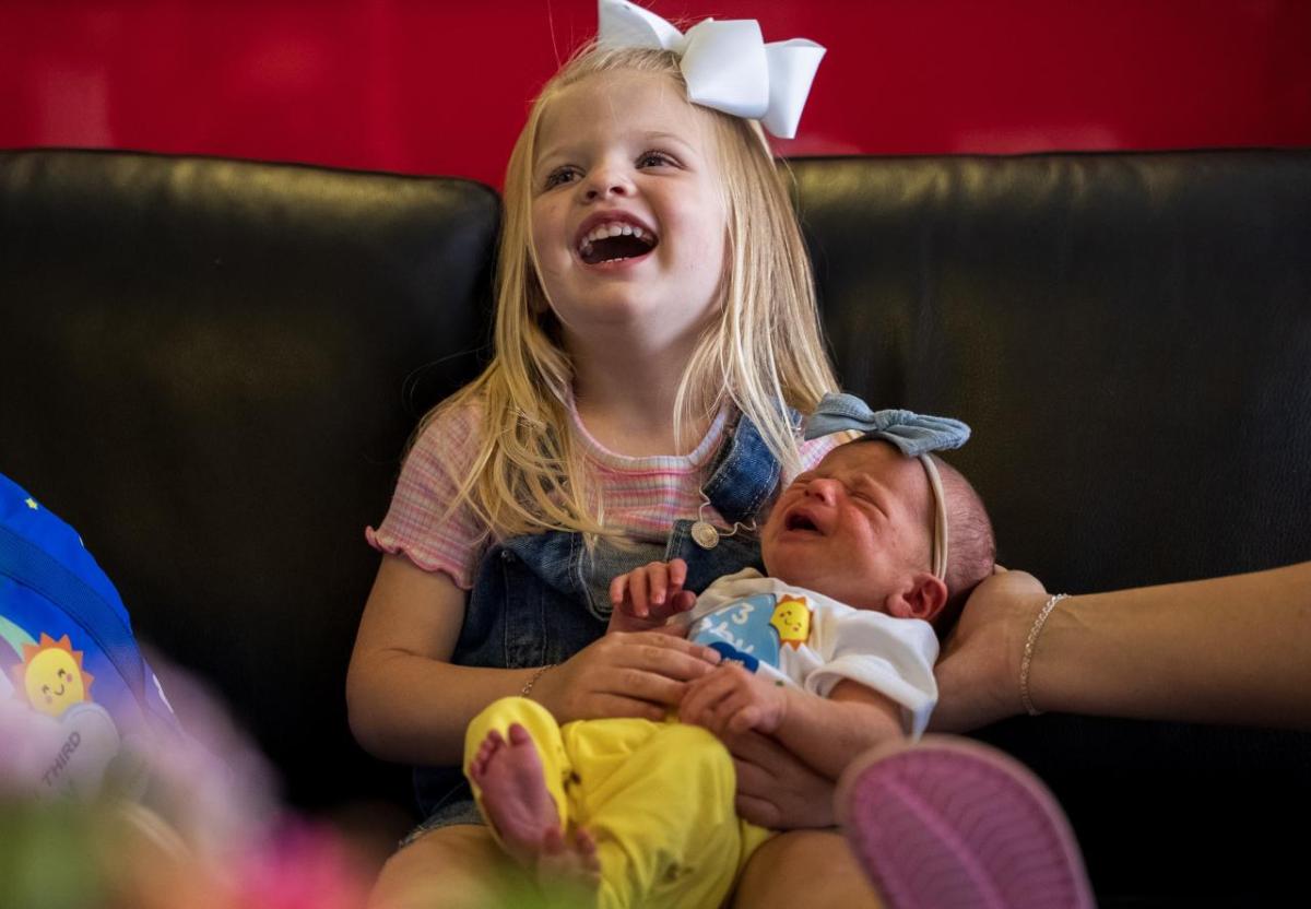 Child holding a baby