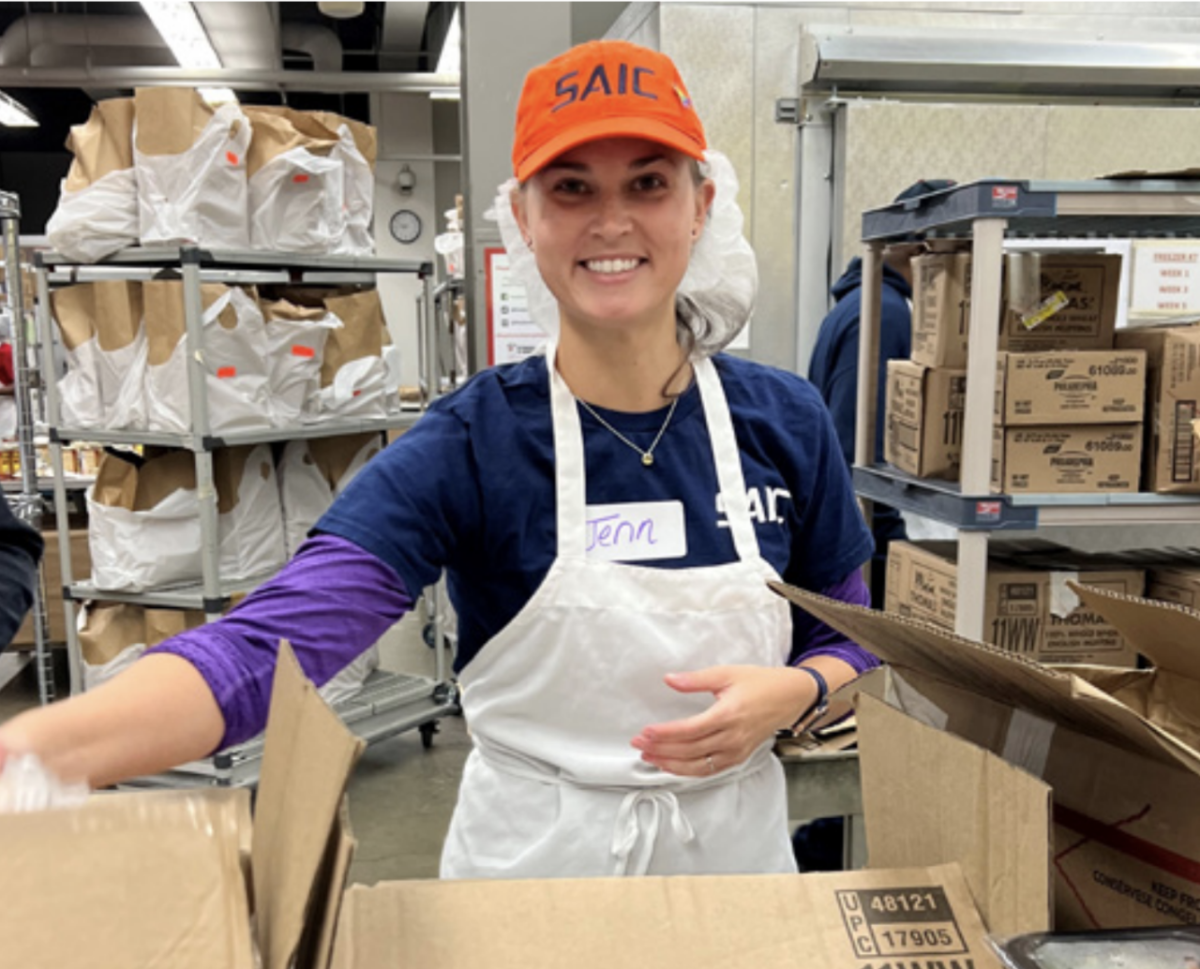 A SAIC employee packing supporting the Washington, D.C.-based Food & Friends 