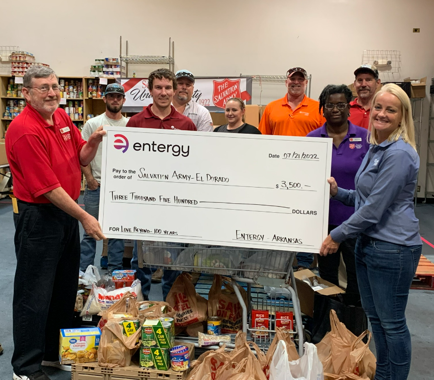 people holding up oversized check from Entergy