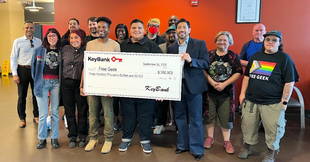 Representatives from Free Geek and KeyBank shown with a grant check for $300,000.