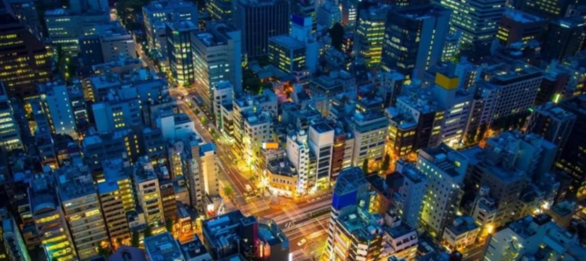 a nighttime city scape, long time-elapsed cars on brightly lit streets