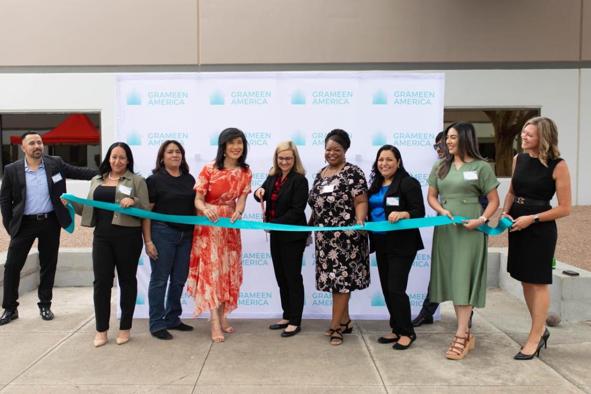 A group of people cutting a ribbon