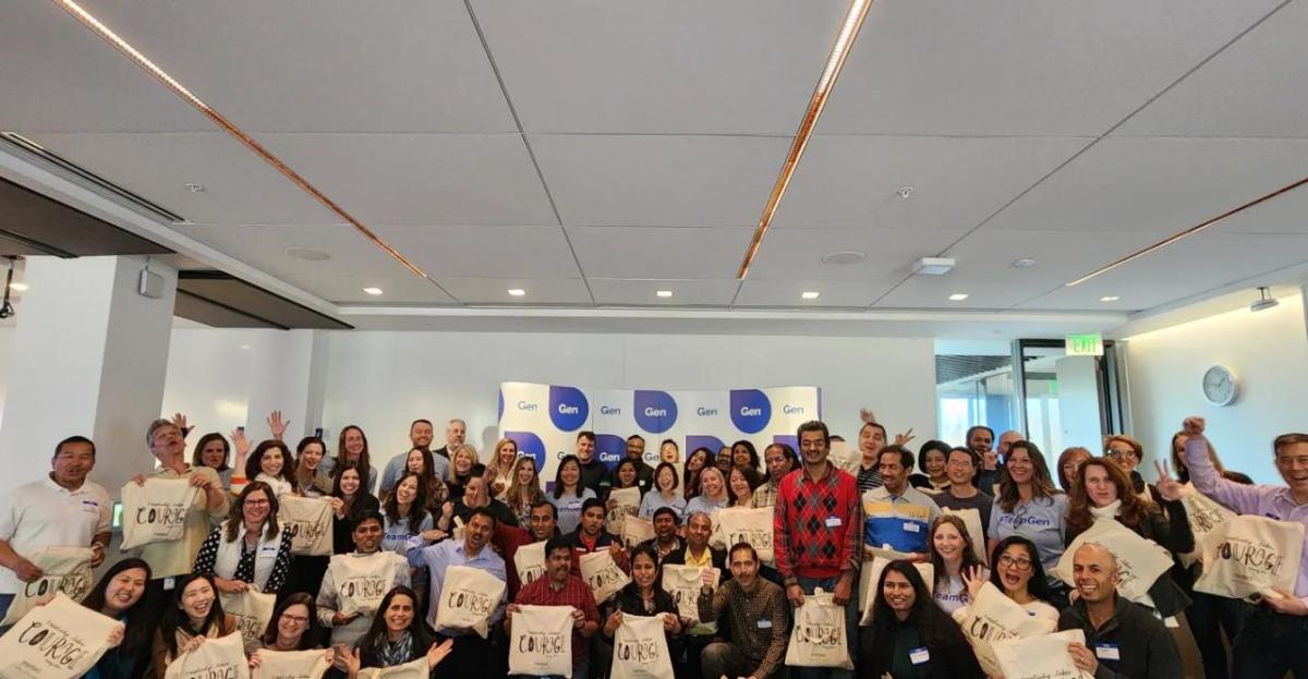 A large group of people holding bags with "Courage" on them.