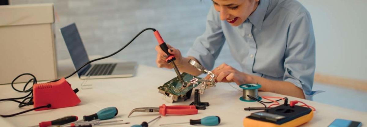 Student working with laptop and tools