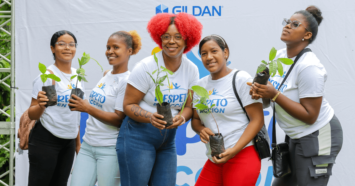 Five employees at a Gildan reforestation event